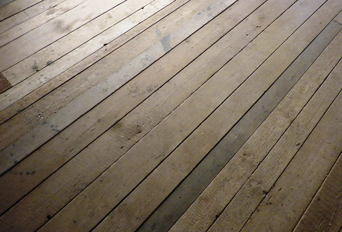 Freshly finished honey-toned deck boards running on a diagonal